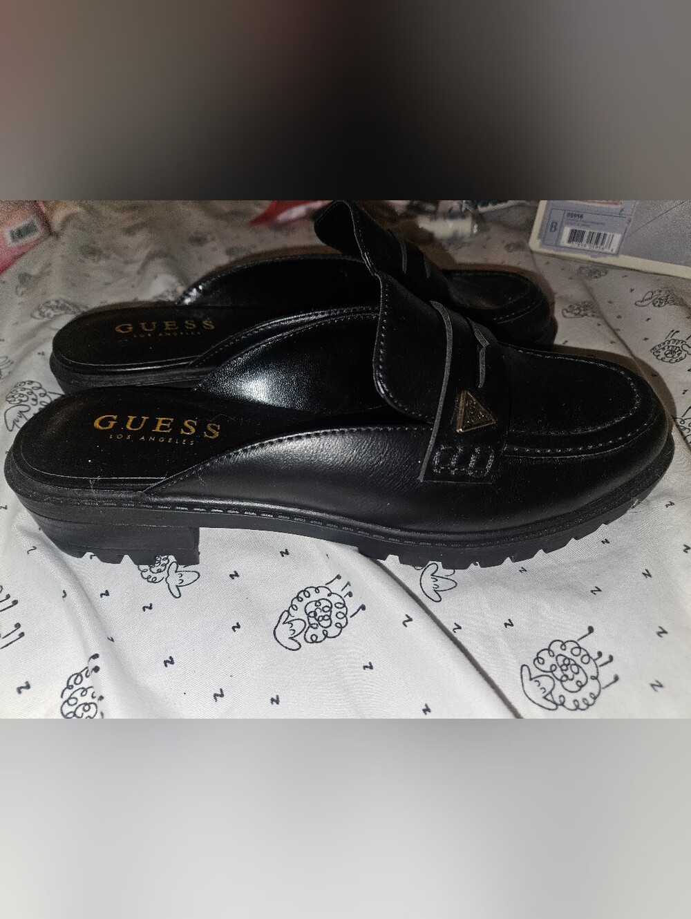 GUESS Black Leather Women’s Slip-On Loafers with Gold Triangle Logo